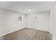 Cozy room with neutral walls, modern baseboards, and luxury vinyl plank flooring at 1049 N Traub Ave, Indianapolis, IN 46222