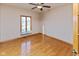 This bedroom is spacious with hardwood floors, neutral walls, ceiling fan, and large window at 1114 Woodridge, Brownsburg, IN 46112