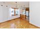 Dining area with hardwood floors, modern light fixture, and view into the kitchen at 1114 Woodridge, Brownsburg, IN 46112