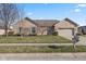 Charming one-story brick home with an attached two-car garage and manicured front lawn at 1114 Woodridge, Brownsburg, IN 46112