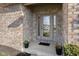 Inviting front entryway with decorative glass door, planters, and brick facade at 1114 Woodridge, Brownsburg, IN 46112