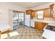 Well-lit kitchen with wood cabinets, neutral countertops, and access to outdoor patio at 1114 Woodridge, Brownsburg, IN 46112