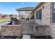 Back patio with brick surround with an outdoor grill, overlooking a small pond and green space at 1114 Woodridge, Brownsburg, IN 46112