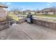 Back patio with brick surround that overlooks a small pond and green space at 1114 Woodridge, Brownsburg, IN 46112