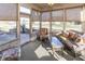 Bright sunroom with cozy wicker furniture, large windows, and a view of the outdoor space at 1114 Woodridge, Brownsburg, IN 46112