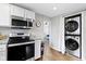 Updated kitchen boasts stainless steel appliances and a convenient washer/dryer combo, maximizing space and functionality at 1240 Wayne St, Noblesville, IN 46060