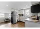 Modern kitchen features stainless steel appliances, granite counters, and a dining area, perfect for Gathering meals at 1240 Wayne St, Noblesville, IN 46060