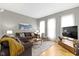 Cozy living room featuring hardwood floors, ample natural light, and comfortable furniture at 1240 Wayne St, Noblesville, IN 46060