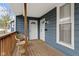 Inviting front porch with a charming wicker chair and view of the entryway at 1240 Wayne St, Noblesville, IN 46060