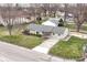 A high angle view of the home showing its lot, landscaping, nearby houses, and neighborhood at 1400 W Cowing Dr, Muncie, IN 47304