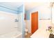 Cozy bathroom featuring a bathtub, a toilet, a sink, and white paneled walls at 1400 W Cowing Dr, Muncie, IN 47304