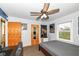 Cozy bedroom featuring a ceiling fan, neutral walls and trim, carpeted floor, and a comfortable bed at 1400 W Cowing Dr, Muncie, IN 47304