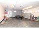 Spacious garage with black tile floors, storage cabinets, and a pool table at 1400 W Cowing Dr, Muncie, IN 47304