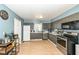 The kitchen has ample gray cabinets, stainless steel appliances, and a functional layout at 1400 W Cowing Dr, Muncie, IN 47304