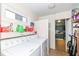Bright laundry area featuring a washer, dryer, and ample shelving at 1400 W Cowing Dr, Muncie, IN 47304