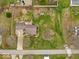 A high angle shot shows a yard with a fence, a small shed, and a garden at 1418 E Maple Dr, Shelbyville, IN 46176