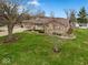 Overhead view of the property showing the home, large lot, and surrounding trees at 1418 E Maple Dr, Shelbyville, IN 46176