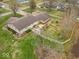 Expansive backyard with a patio, mature trees, and a charming white picket fence, offering privacy at 1418 E Maple Dr, Shelbyville, IN 46176