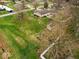 A high angle shot shows a green back lawn, a fence, a small shed, and a garden at 1418 E Maple Dr, Shelbyville, IN 46176