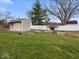 Backyard featuring a shed, garden beds, and a well-manicured lawn, perfect for gardening at 1418 E Maple Dr, Shelbyville, IN 46176