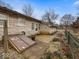 Backyard view featuring a patio, gravel area, and access to the basement at 1418 E Maple Dr, Shelbyville, IN 46176