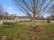 Spacious backyard with a swing set, mature trees, and well-maintained lawn, ideal for outdoor enjoyment at 1418 E Maple Dr, Shelbyville, IN 46176