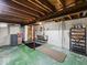 An unfinished basement area with exposed ceiling and laundry sink at 1418 E Maple Dr, Shelbyville, IN 46176