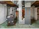 An unfinished basement with painted walls, exposed ceiling, and wood burning stove at 1418 E Maple Dr, Shelbyville, IN 46176