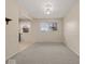 A bright dining room features gray carpet, natural light, and neutral paint at 1418 E Maple Dr, Shelbyville, IN 46176