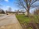 Beautiful home with a spacious driveway, lush lawn, and mature tree at 1418 E Maple Dr, Shelbyville, IN 46176