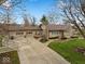 Aerial view of the charming home highlighting the spacious driveway and manicured lawn at 1418 E Maple Dr, Shelbyville, IN 46176