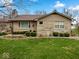 A single-story home with a stone facade, updated windows, and a well-maintained lawn at 1418 E Maple Dr, Shelbyville, IN 46176