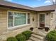 Charming front entrance with stone facade, covered entry, and manicured landscaping at 1418 E Maple Dr, Shelbyville, IN 46176