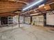 Spacious garage interior showcasing ample storage, two garage doors, and shelving at 1418 E Maple Dr, Shelbyville, IN 46176