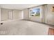 Spacious living room with large window, neutral carpet, and ample natural light at 1418 E Maple Dr, Shelbyville, IN 46176