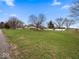 Expansive lot featuring a well-maintained lawn and mature trees at 1418 E Maple Dr, Shelbyville, IN 46176