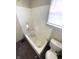 Simple bathroom featuring a standard tub and toilet, showing wear and tear at 1437 Kappes St, Indianapolis, IN 46221