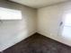 Cozy bedroom features neutral walls, dark carpet, and natural light from two windows at 1437 Kappes St, Indianapolis, IN 46221