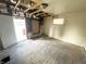 Interior view showing exposed ceiling joists, damaged walls and floors at 1437 Kappes St, Indianapolis, IN 46221