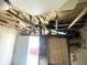 Interior view showing exposed ceiling joists, damaged walls and floors at 1437 Kappes St, Indianapolis, IN 46221