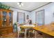 Dining room featuring wood floors, a dining table, and window with sheer curtains at 15 N Fleming St, Indianapolis, IN 46222