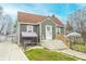 Charming exterior showcasing gray siding, and a cozy front porch swing and steps at 15 N Fleming St, Indianapolis, IN 46222