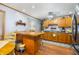 Spacious kitchen with wood cabinets, and a center island with a breakfast bar at 15 N Fleming St, Indianapolis, IN 46222