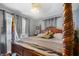 Well-lit main bedroom featuring a large four-poster bed with striped linens and soft, natural lighting at 15 N Fleming St, Indianapolis, IN 46222