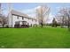 Expansive backyard with well-manicured lawn, mature trees, and a deck at 15638 River Birch Rd, Westfield, IN 46074