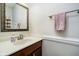 Updated half bathroom with wood vanity, neutral paint, stylish mirror, and towel rack at 15638 River Birch Rd, Westfield, IN 46074