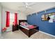 Bedroom with dark furniture, blue accent wall, and ceiling fan at 15638 River Birch Rd, Westfield, IN 46074