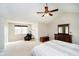 Bedroom features a ceiling fan, vaulted ceilings, neutral carpet, and an accent chair with natural light at 15638 River Birch Rd, Westfield, IN 46074