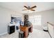 Spacious bedroom office featuring a wooden desk, neutral carpet, ceiling fan, and ample natural light at 15638 River Birch Rd, Westfield, IN 46074