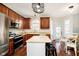 Open concept kitchen boasts stainless steel appliances, island with seating, and lots of natural light at 15638 River Birch Rd, Westfield, IN 46074